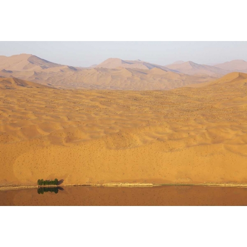 China, Badain Jaran Desert vastness next to lake
